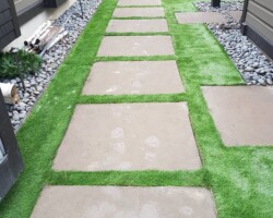 Stone slab walkway in artificial turf
