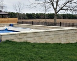 Pool deck within retaining wall