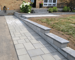 Front entrance, driveway extension and retaining wall