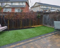 Small backyard with artificial turf and patio