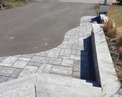 Paved driveway with stone border and steps